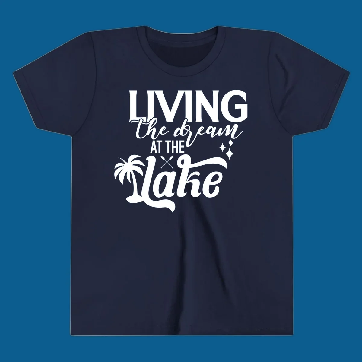 Living the dream at the lake text with palm tree and oars graphic