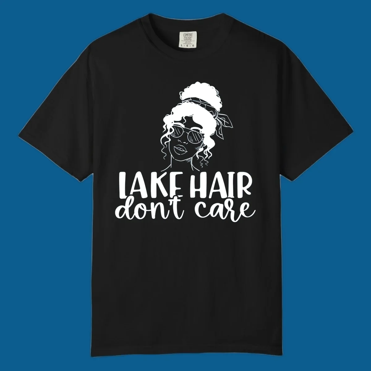 Illustration of a woman with sunglasses and messy bun, with text 'Lake Hair Don't Care'.