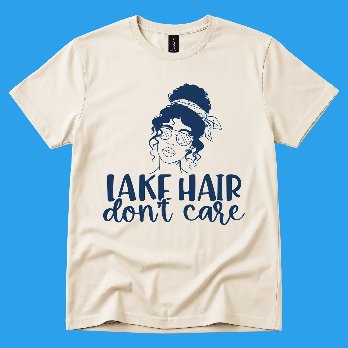 Illustration of a woman with sunglasses and messy bun, with text 'Lake Hair Don't Care'.
