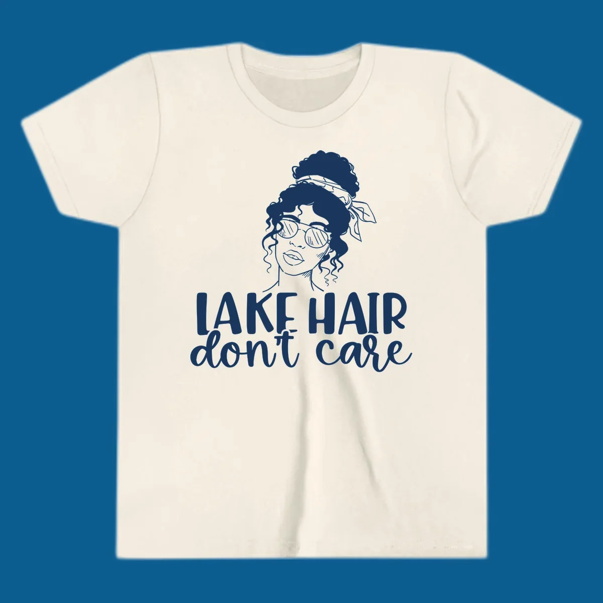 Illustration of a woman with sunglasses and messy bun, with text 'Lake Hair Don't Care'.