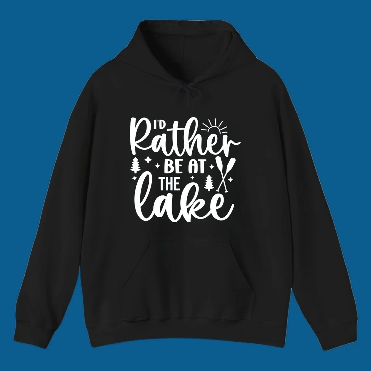 I'd Rather Be At The Lake typography design with sun rays, trees, and oars.