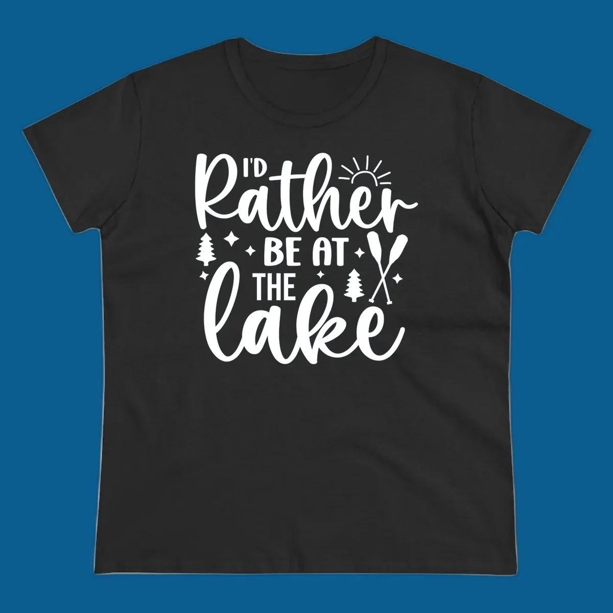 I'd Rather Be At The Lake typography design with sun rays, trees, and oars.