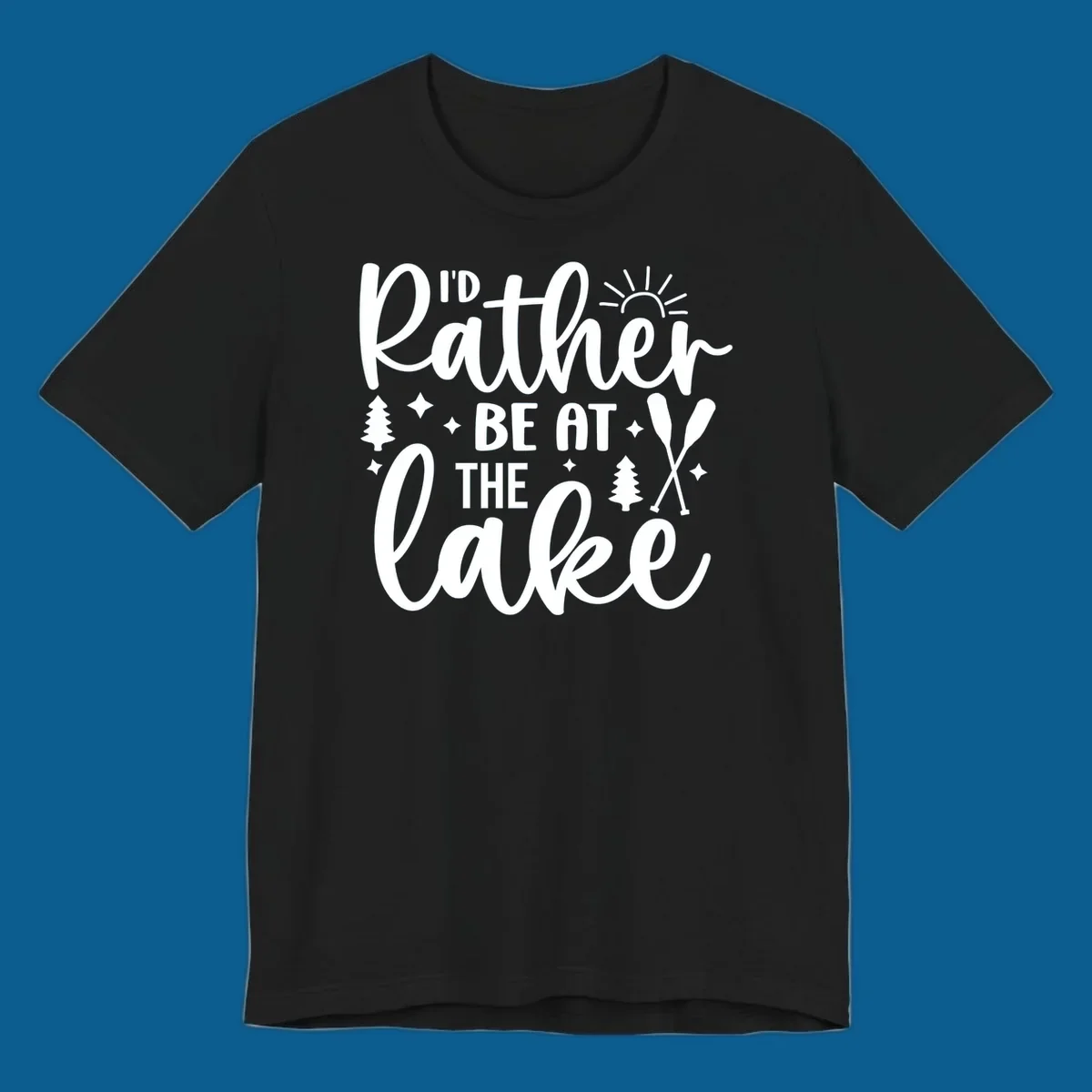 I'd Rather Be At The Lake typography design with sun rays, trees, and oars.