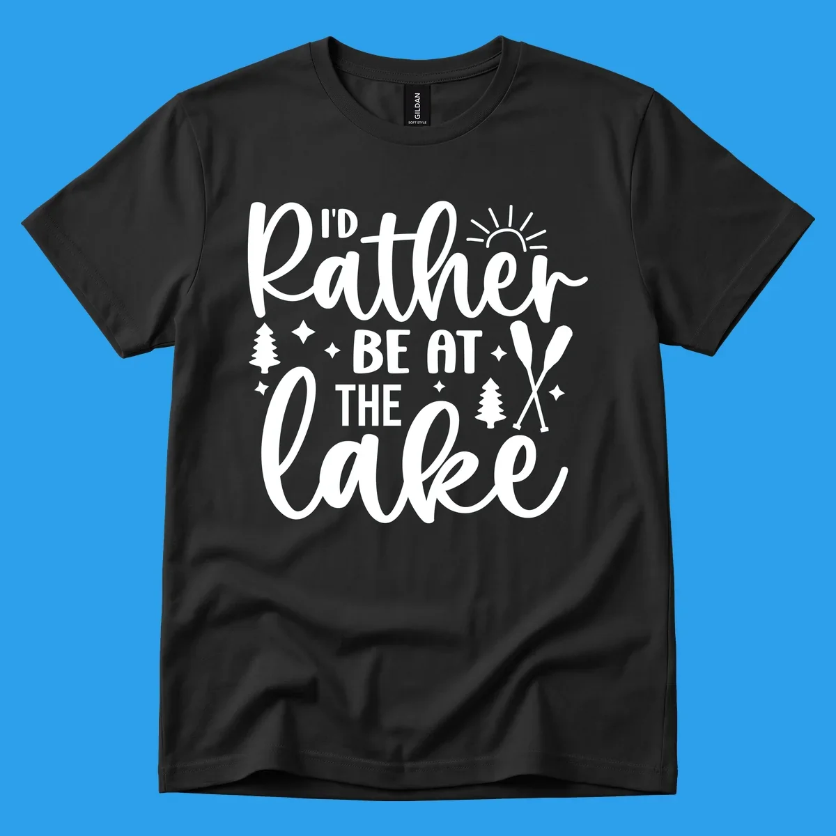 I'd Rather Be At The Lake typography design with sun rays, trees, and oars.