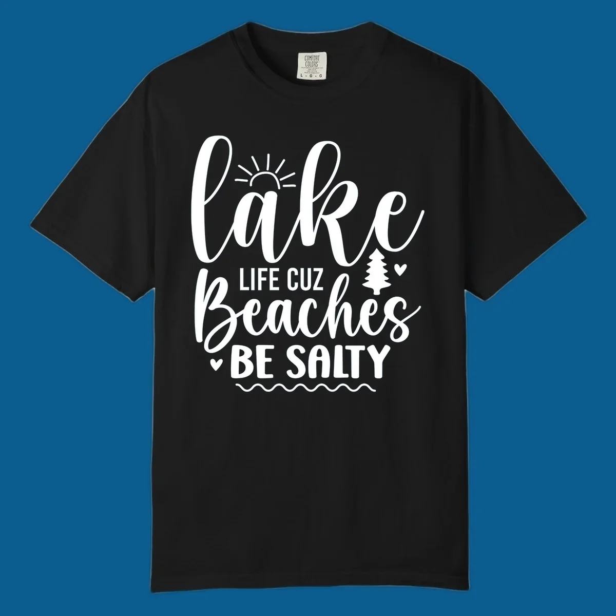 Lake life cuz beaches be salty text design with sun and tree elements.