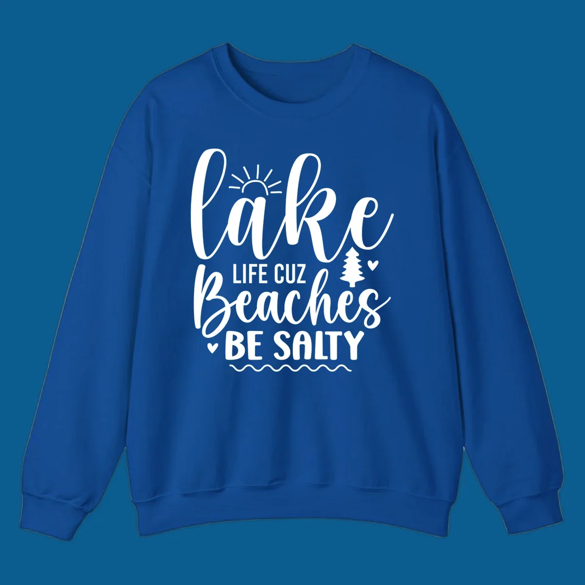Lake life cuz beaches be salty text design with sun and tree elements.
