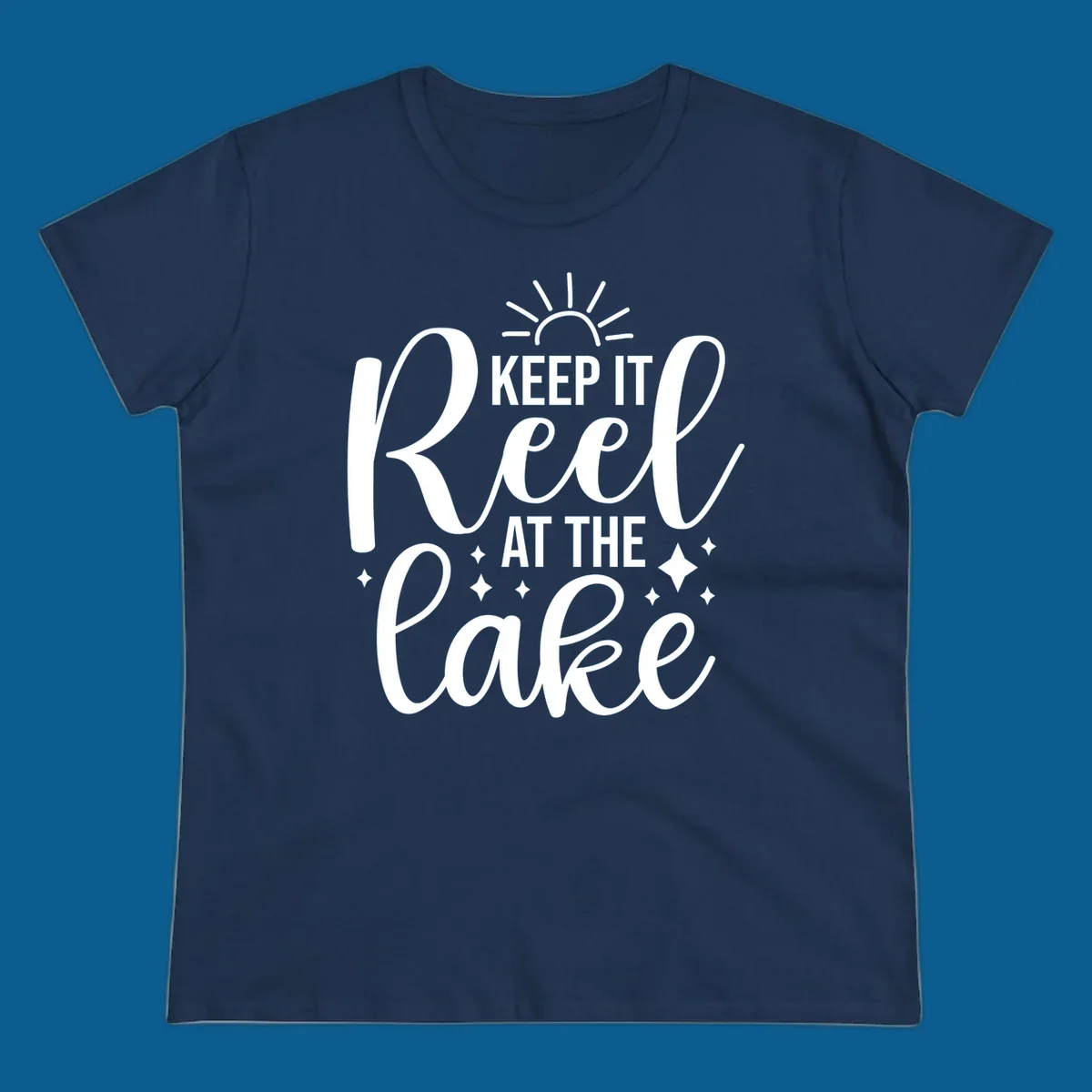 Keep It Reel At The Lake design with sun rays and sparkles, a lakeside lifestyle graphic.