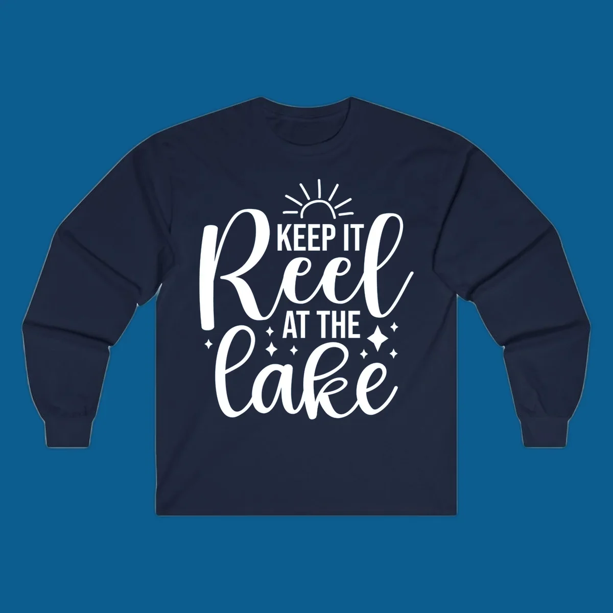 Keep It Reel At The Lake design with sun rays and sparkles, a lakeside lifestyle graphic.