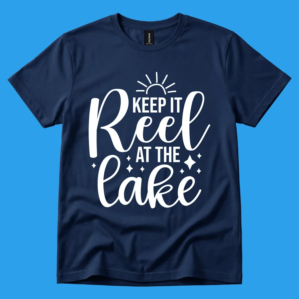 Keep It Reel At The Lake design with sun rays and sparkles, a lakeside lifestyle graphic.