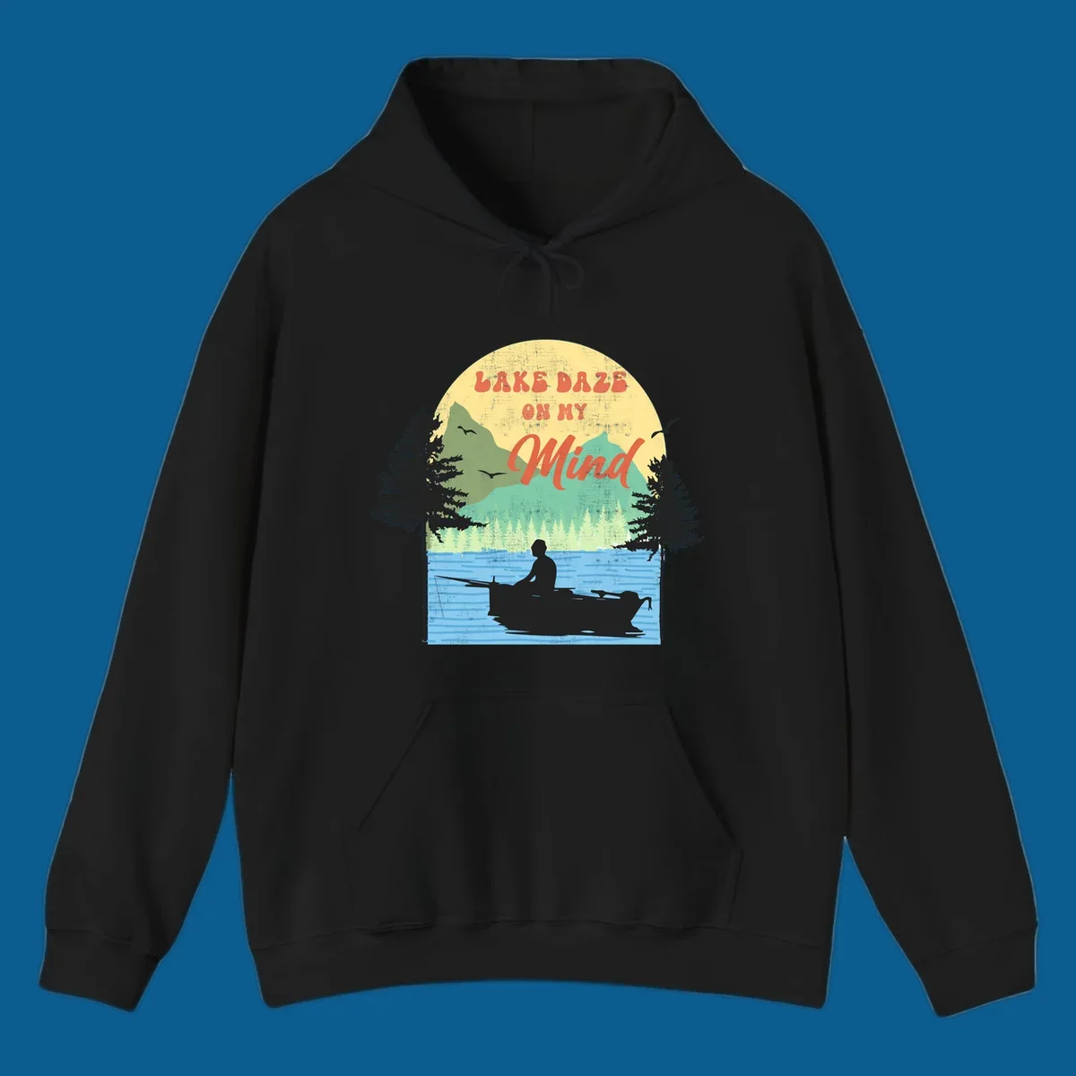 Lake daze fishing design featuring a person in a boat on a lake with trees and mountains.