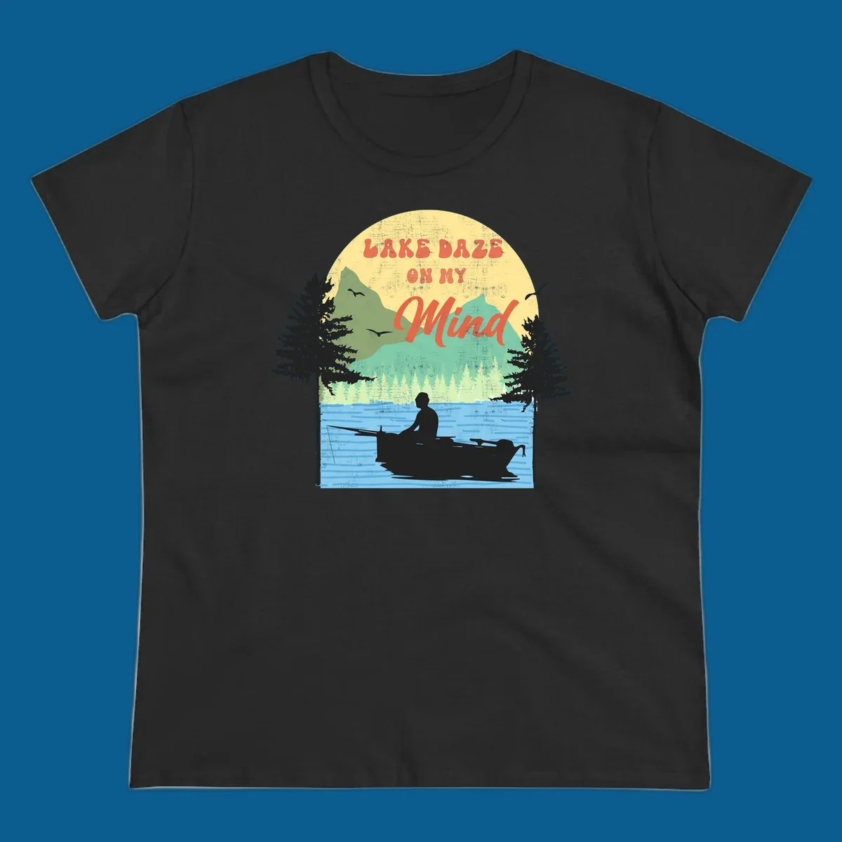 Lake daze fishing design featuring a person in a boat on a lake with trees and mountains.