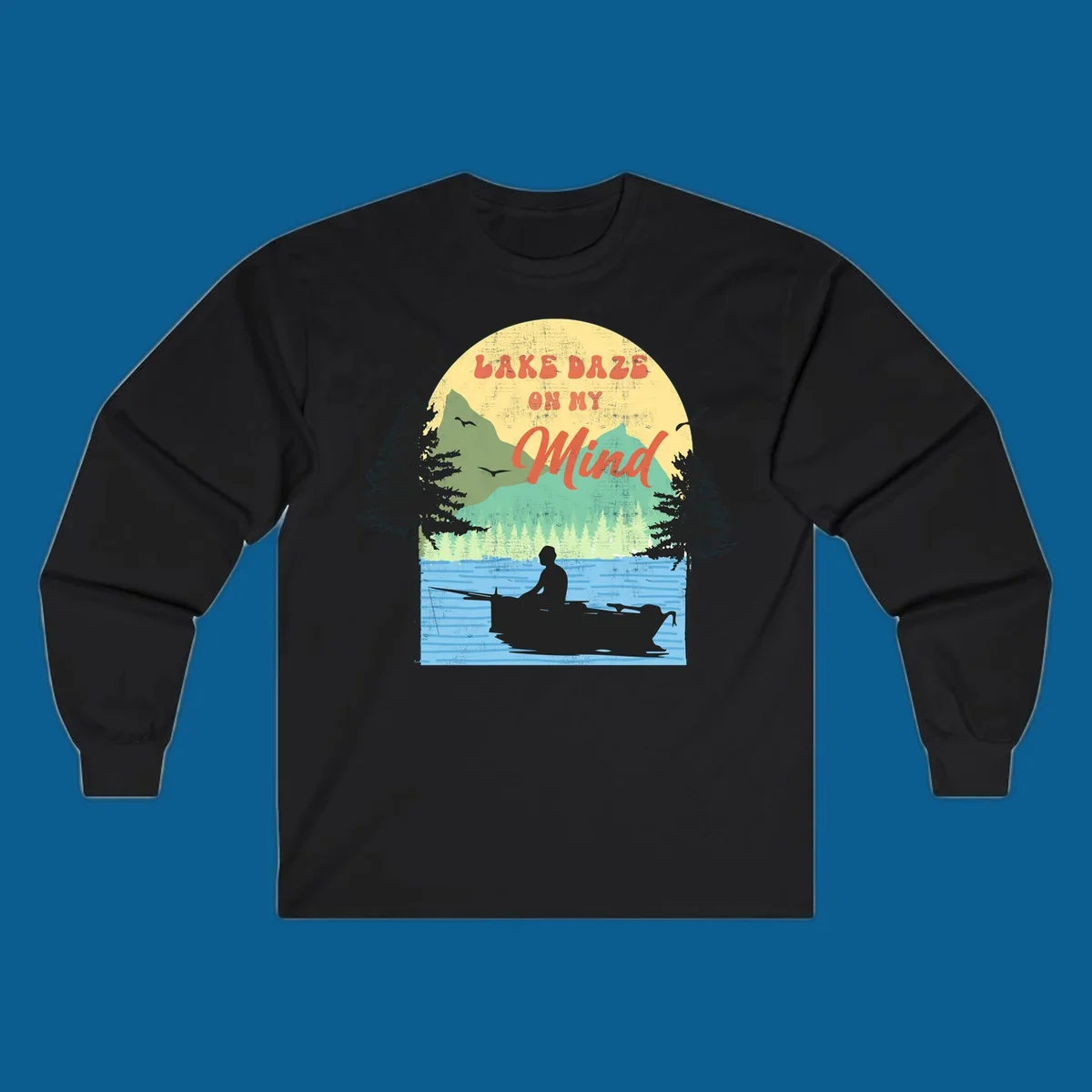 Lake daze fishing design featuring a person in a boat on a lake with trees and mountains.