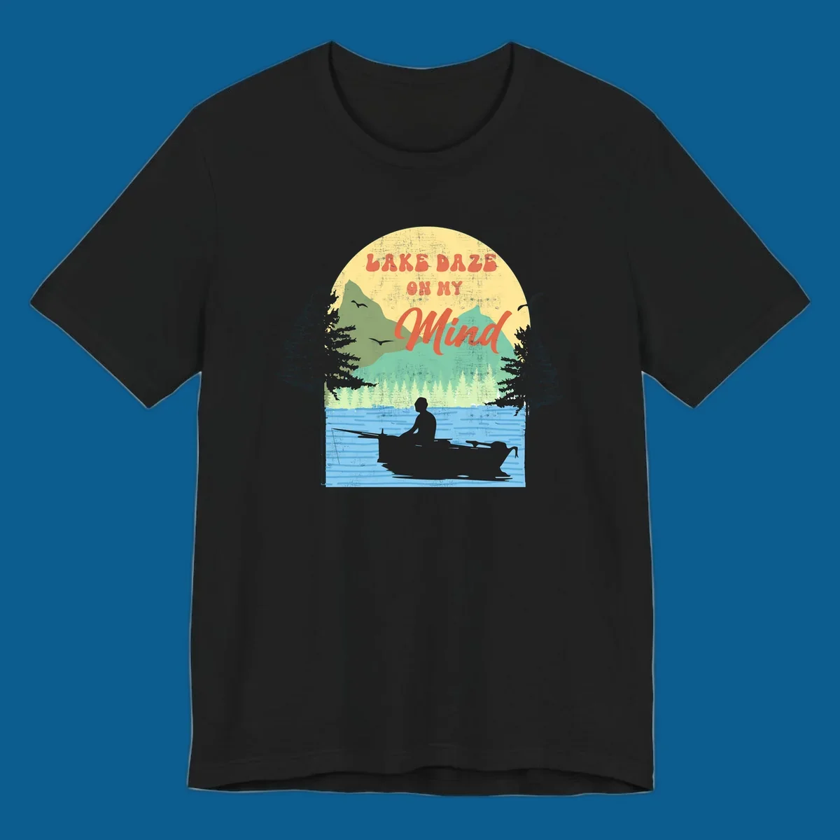 Lake daze fishing design featuring a person in a boat on a lake with trees and mountains.