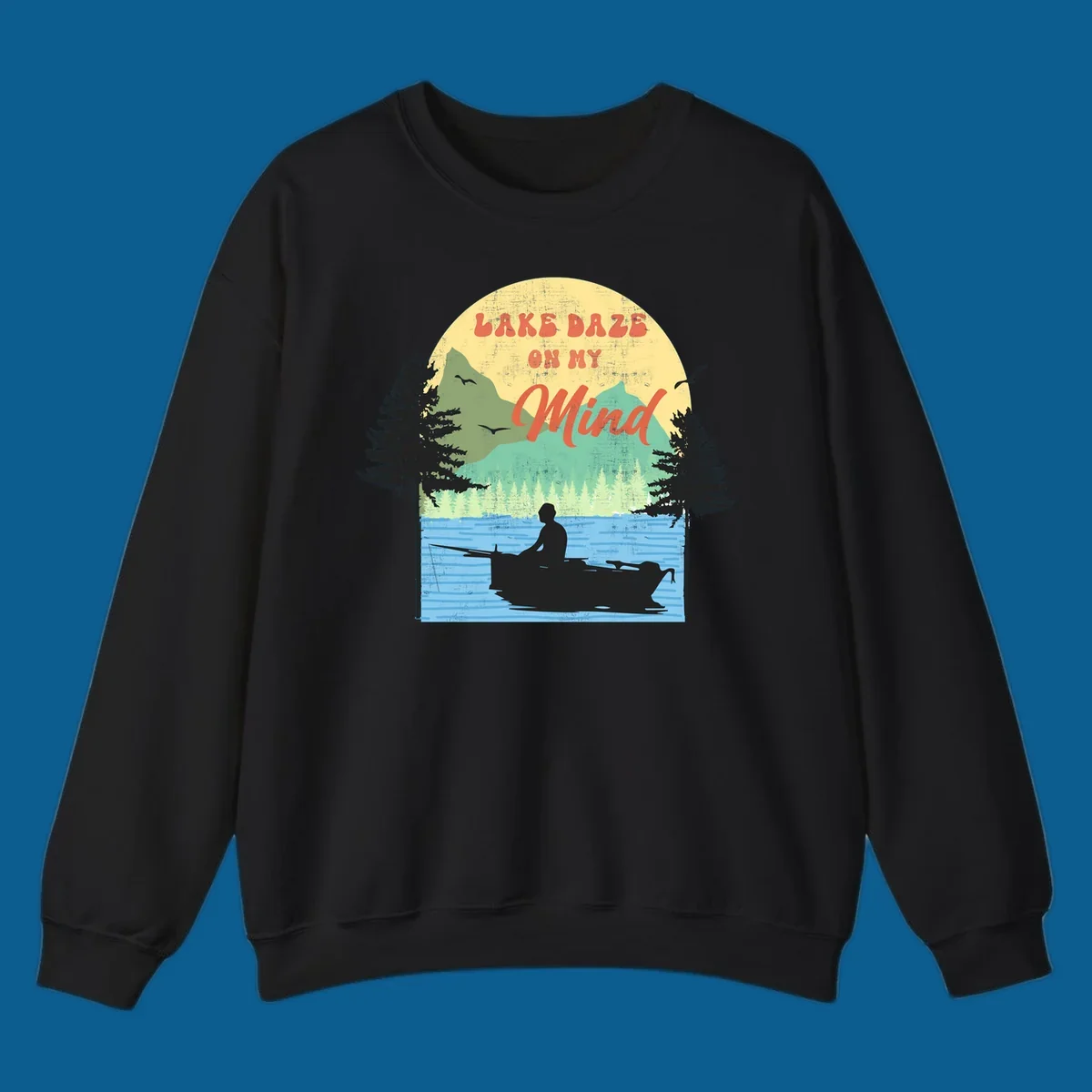 Lake daze fishing design featuring a person in a boat on a lake with trees and mountains.