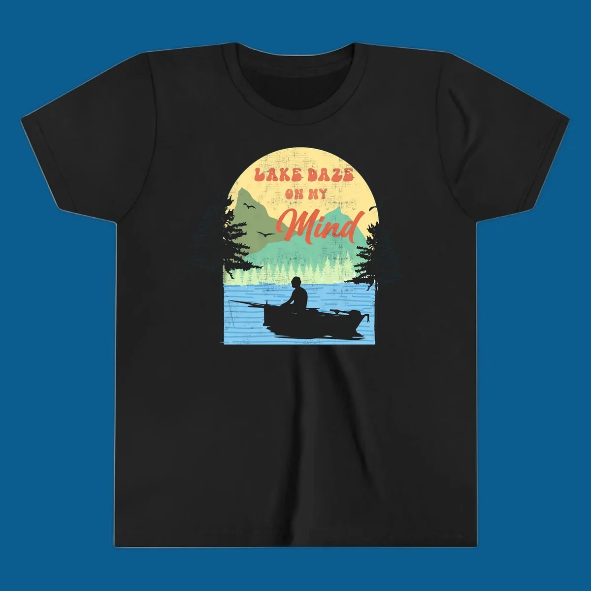 Lake daze fishing design featuring a person in a boat on a lake with trees and mountains.