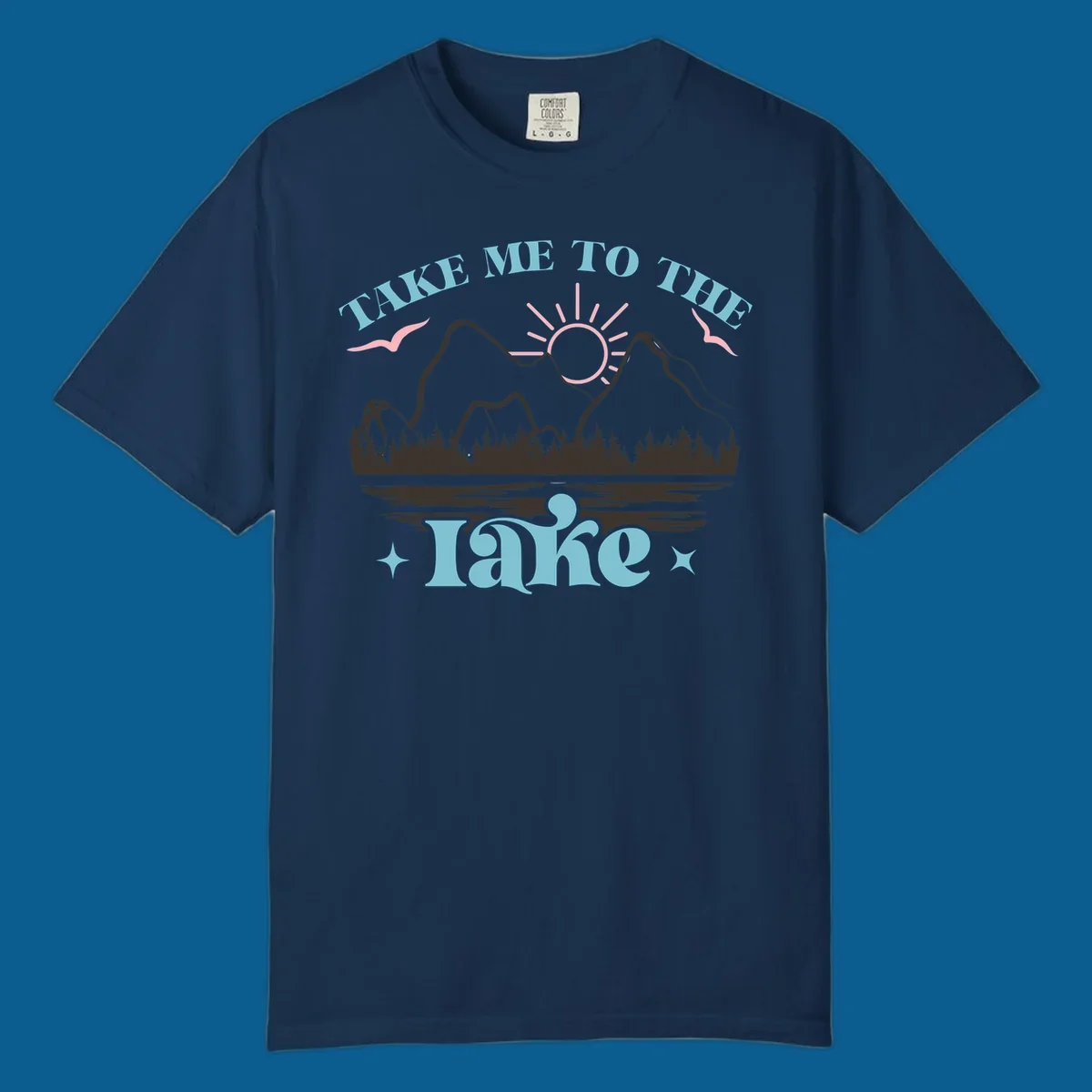 Illustration of mountains, lake, sun, and birds with text 'Take Me To The Lake'.