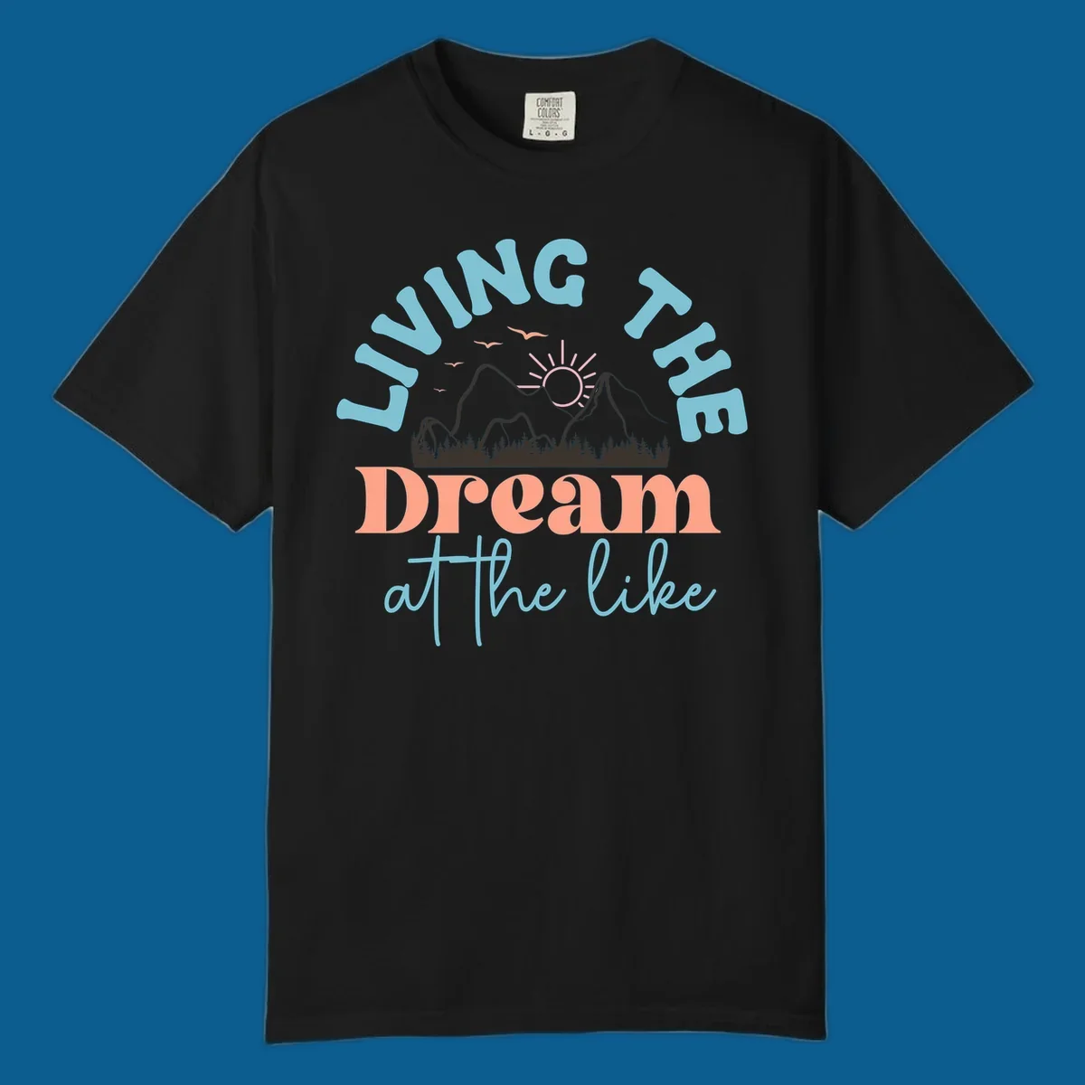 Illustration of mountains with a sunrise and birds above the text 'Living The Dream At The Like'.