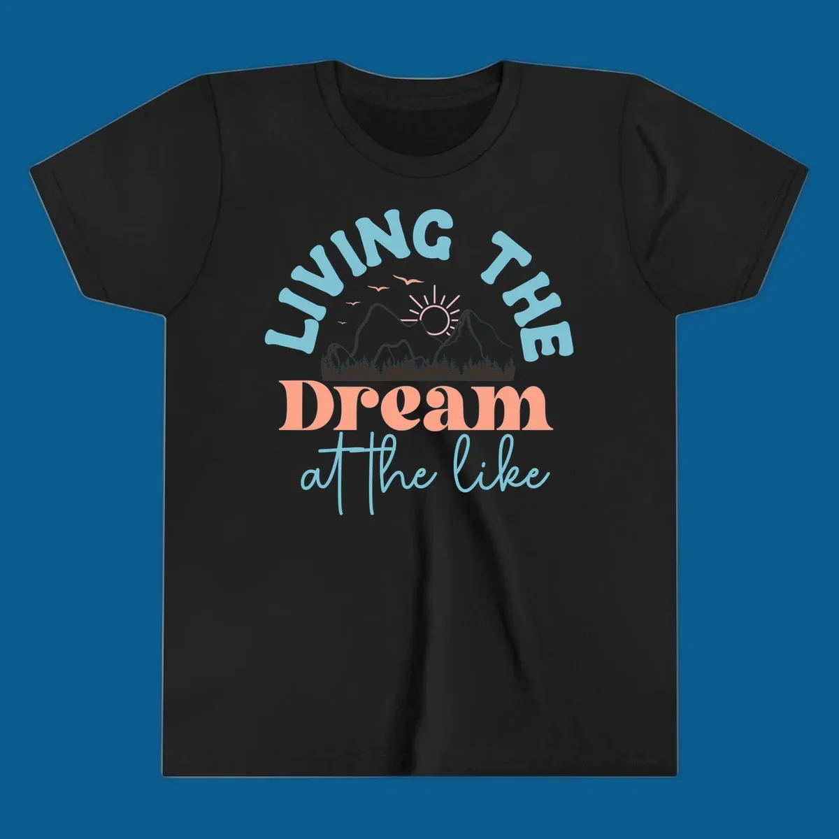 Illustration of mountains with a sunrise and birds above the text 'Living The Dream At The Like'.