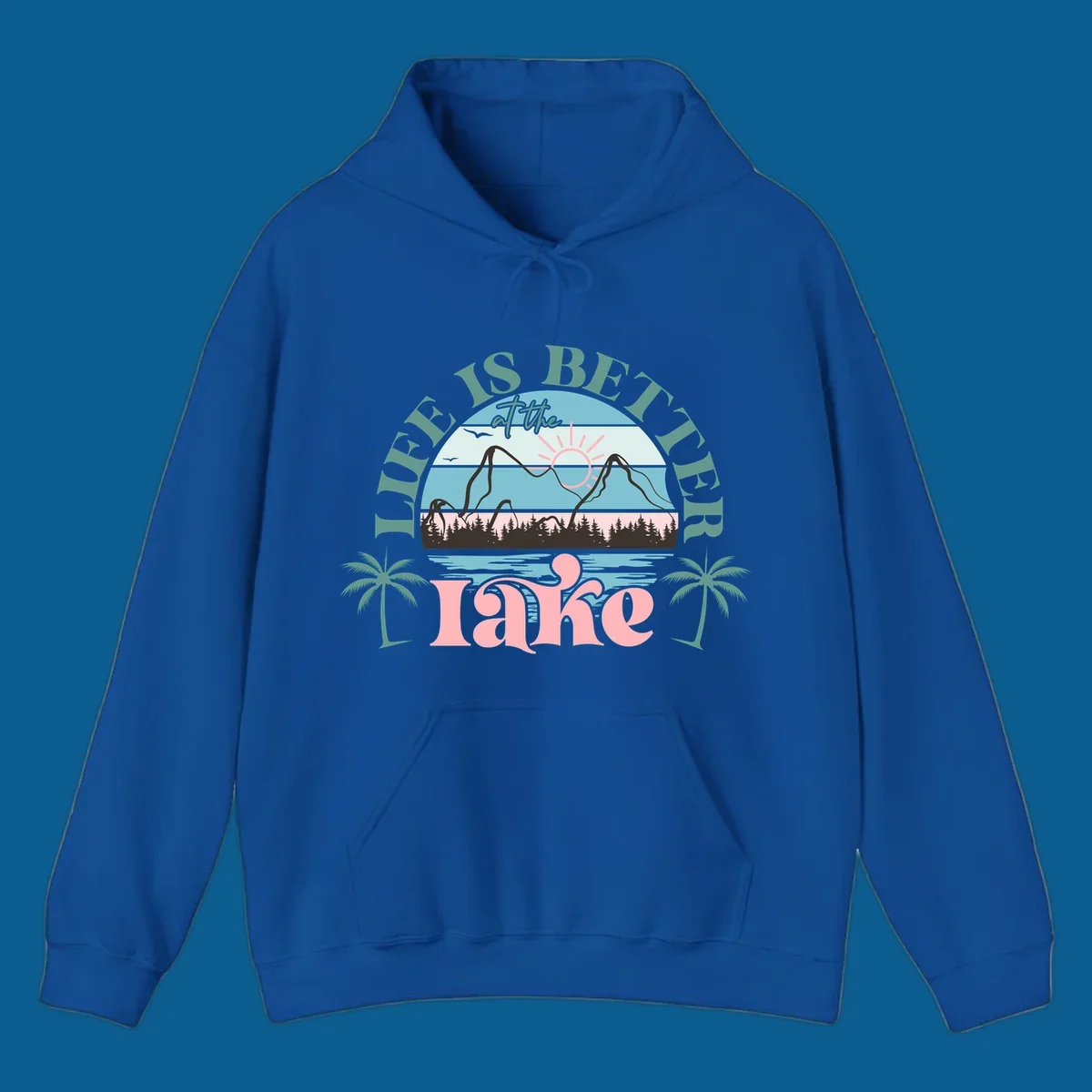 Life is better at the lake scenic design with mountains, trees, lake, and palm trees.