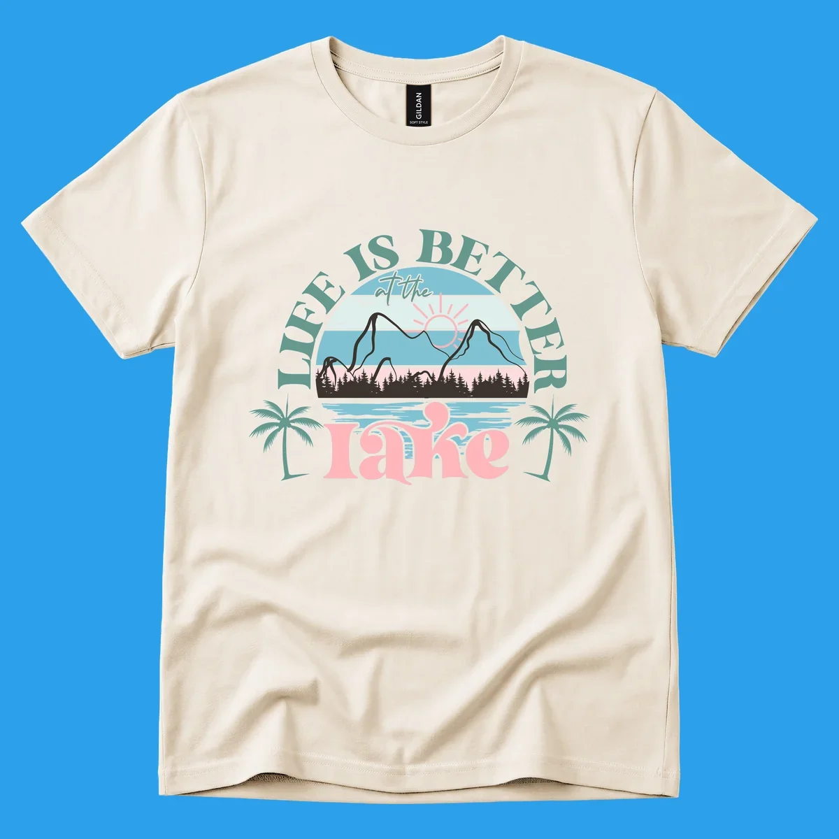 Life is better at the lake scenic design with mountains, trees, lake, and palm trees.