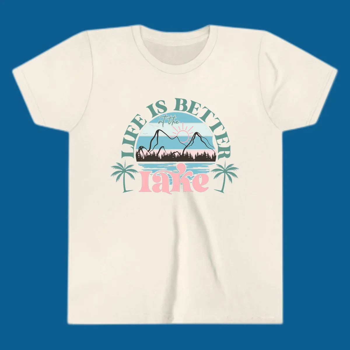Life is better at the lake scenic design with mountains, trees, lake, and palm trees.
