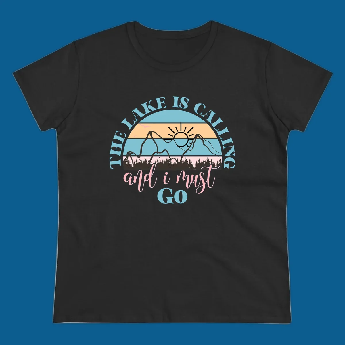 The Lake Is Calling And I Must Go text with mountain and sunset illustration.