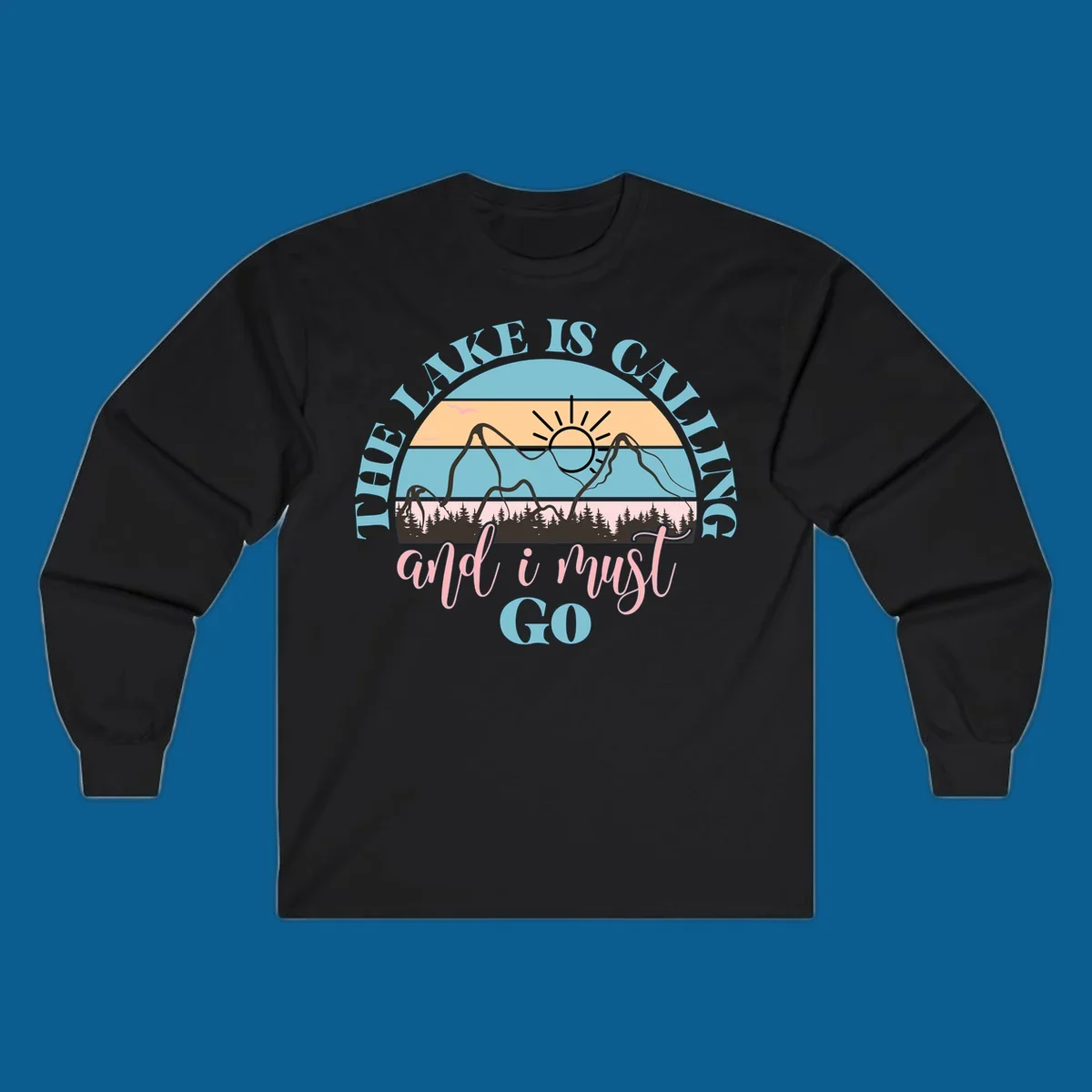 The Lake Is Calling And I Must Go text with mountain and sunset illustration.