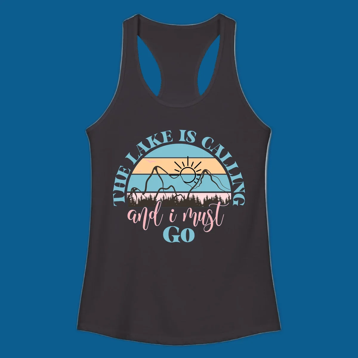 The Lake Is Calling And I Must Go text with mountain and sunset illustration.