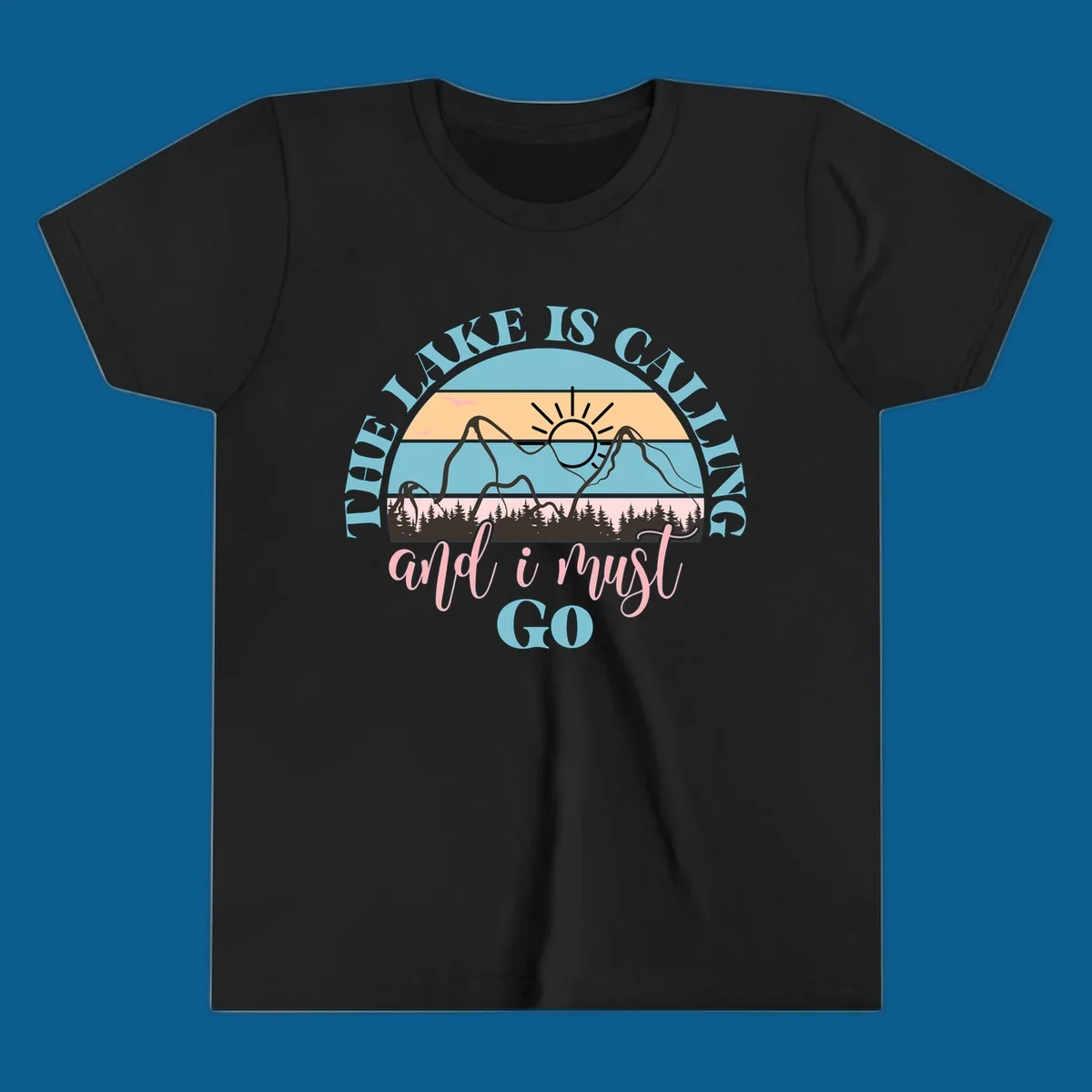 The Lake Is Calling And I Must Go text with mountain and sunset illustration.