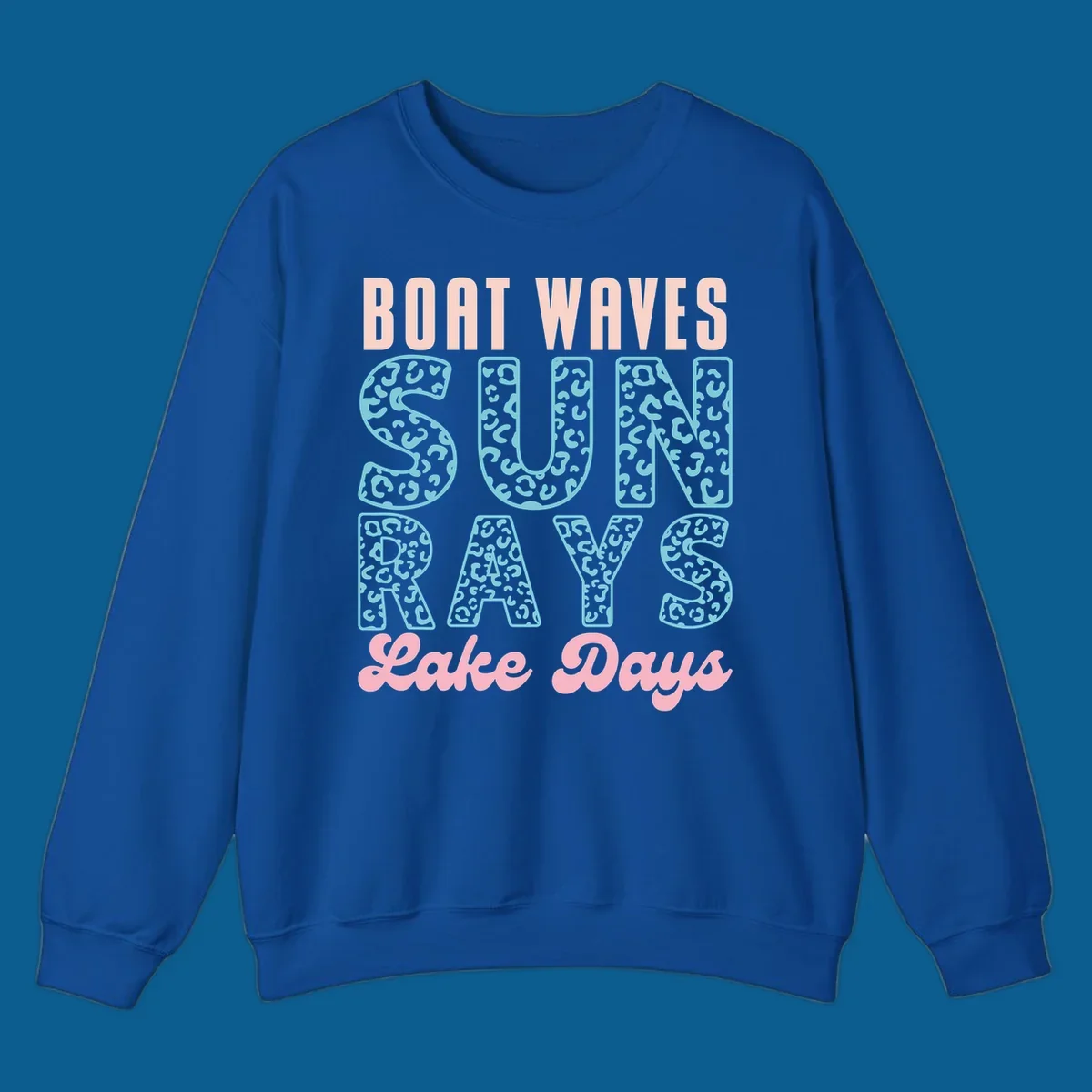 Boat waves sun rays lake days text design with pink and teal leopard print.