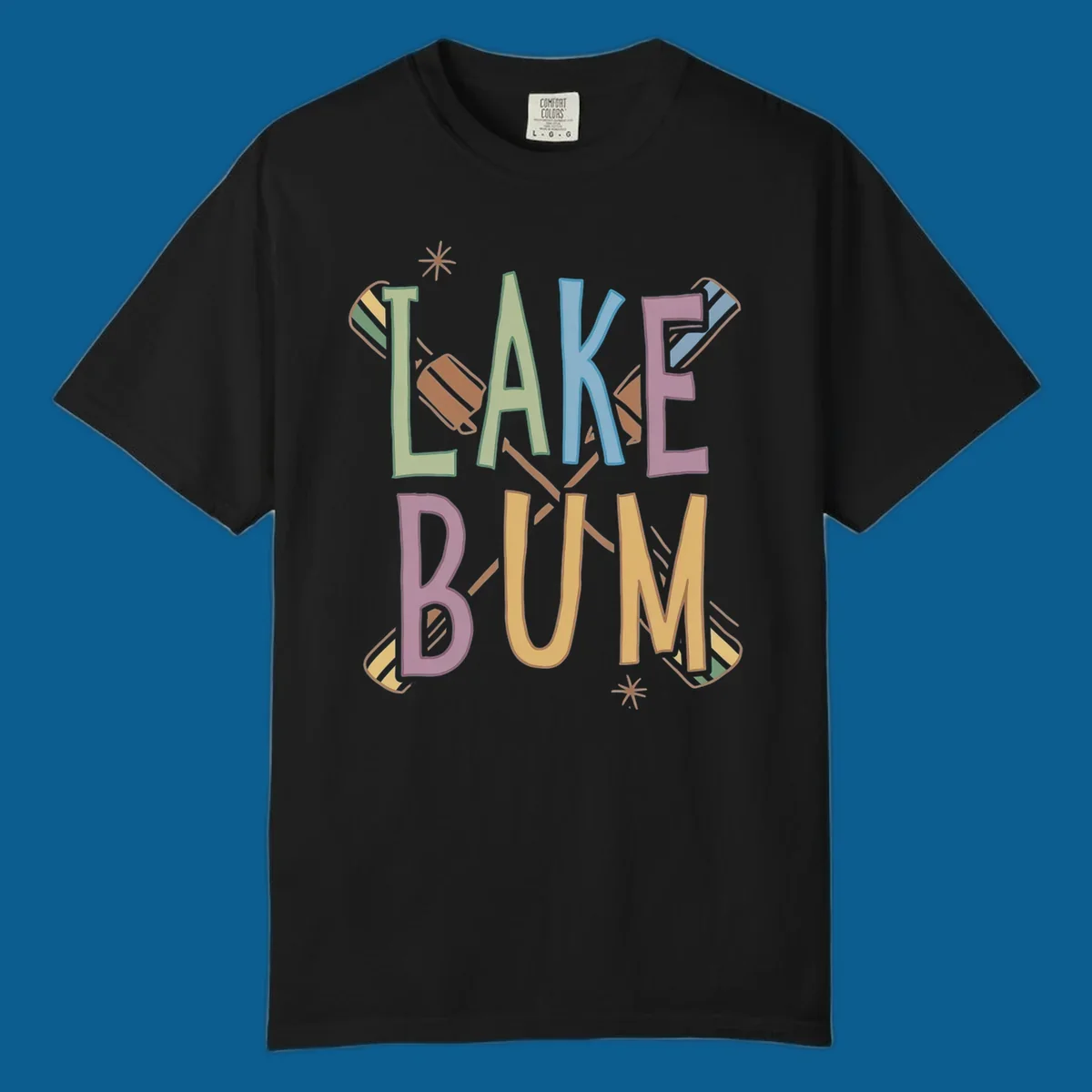 Lake Bum text with crossed oars and starbursts in colorful hand-drawn lettering.