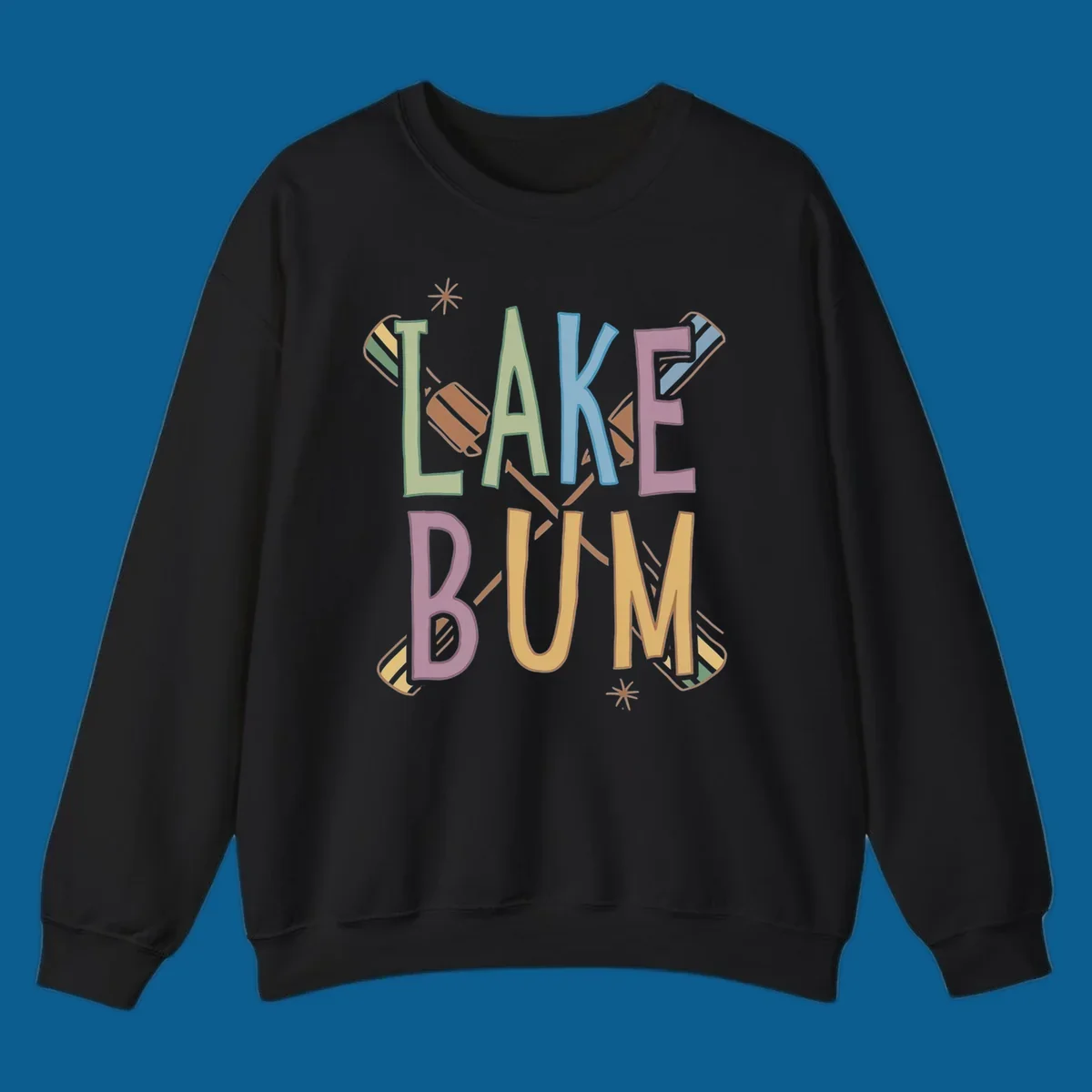 Lake Bum text with crossed oars and starbursts in colorful hand-drawn lettering.