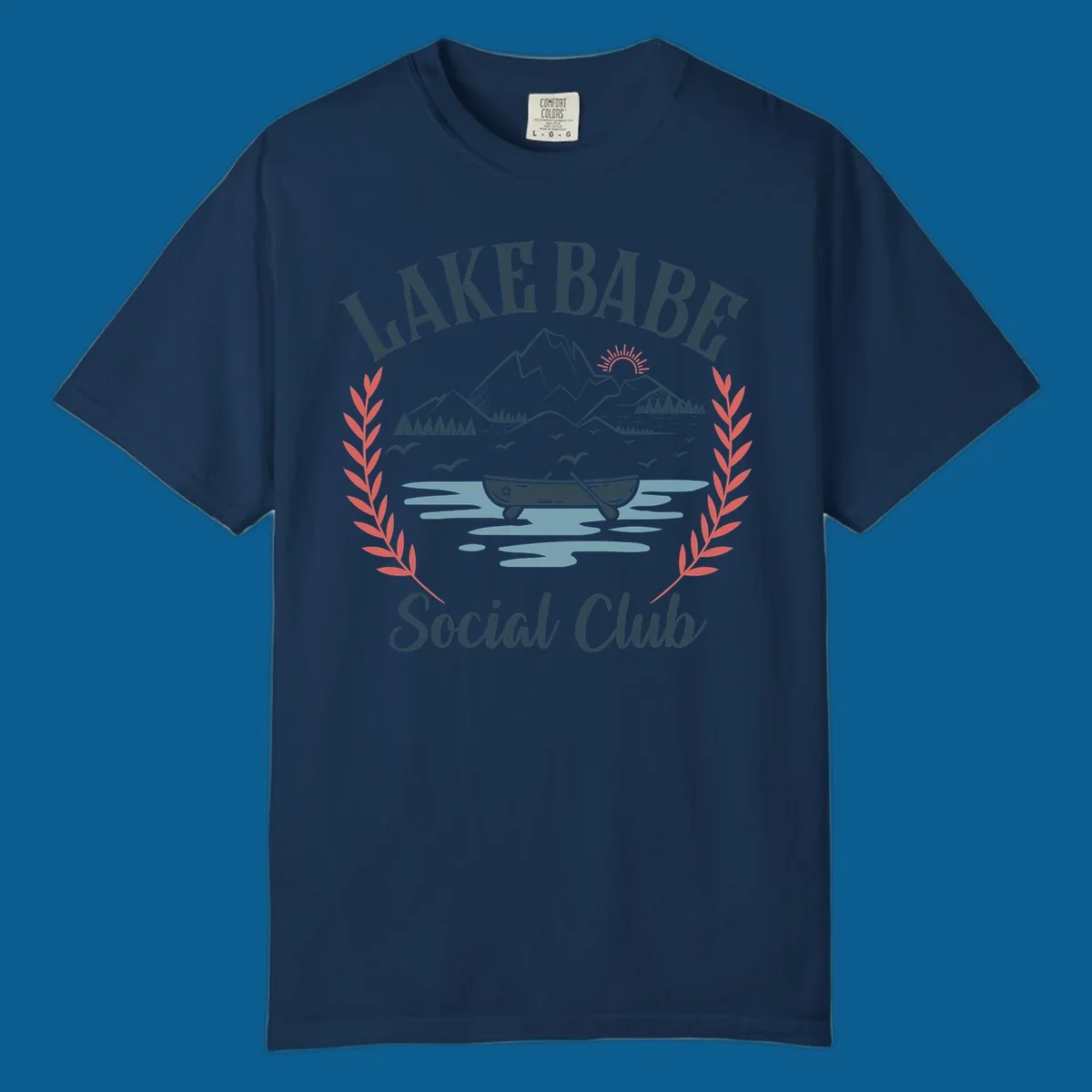 Lake Babe Social Club illustration with mountains, canoe, sun, and birds.