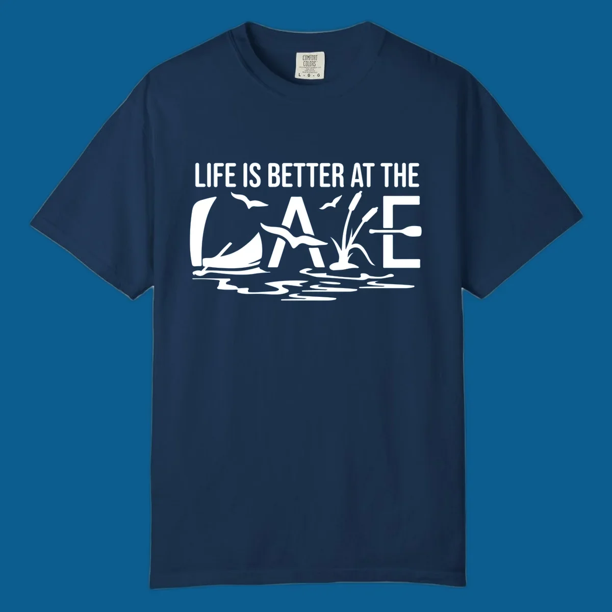 Life Is Better At The Lake design with sailboat, birds, reeds, paddle, and text.