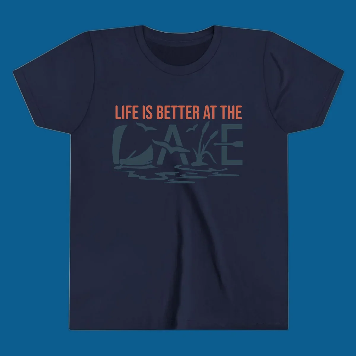 Graphic text design 'LIFE IS BETTER AT THE LAKE' with sailboat, birds, cattails, and paddle elements.