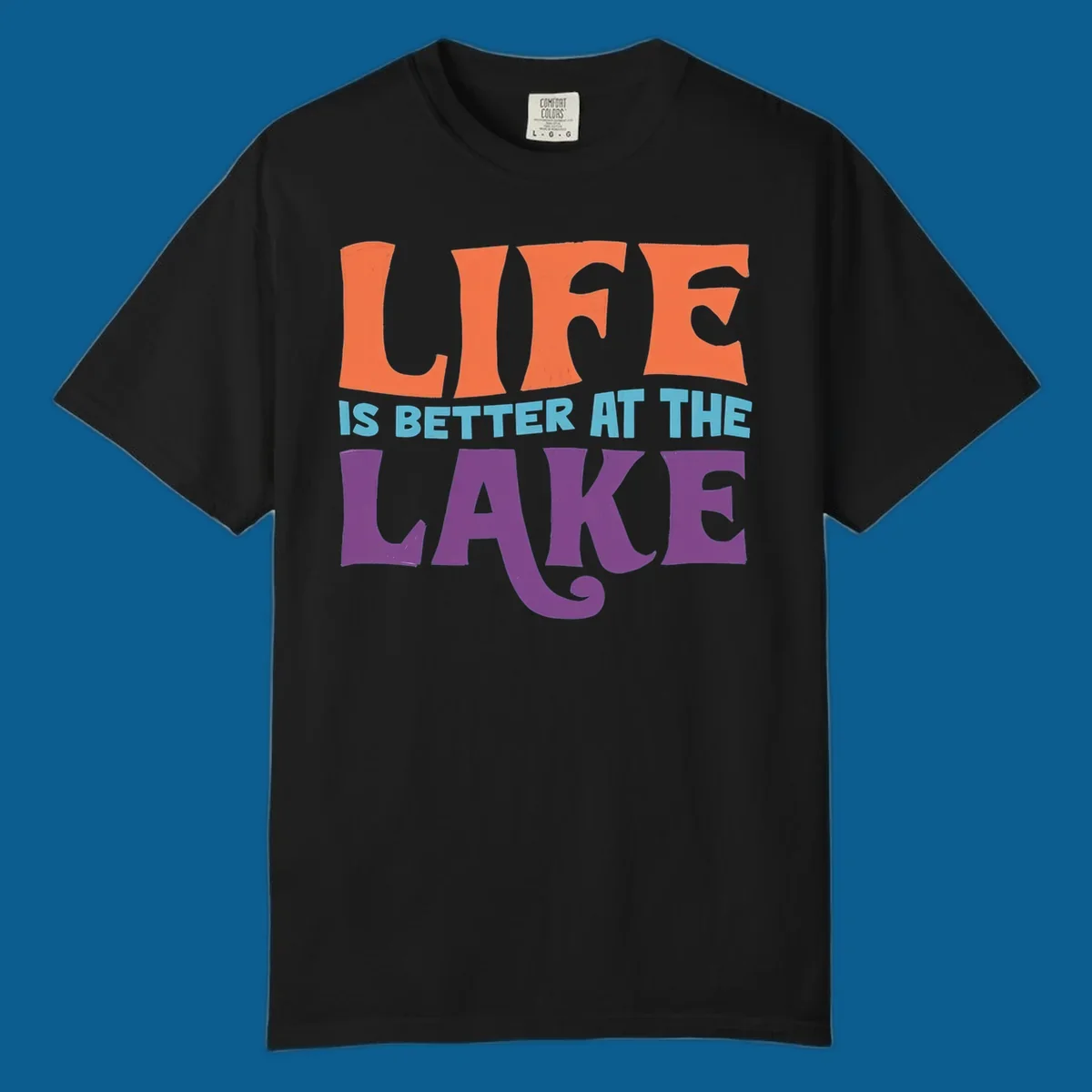 Retro typography design stating "LIFE IS BETTER AT THE LAKE" in orange, teal, and purple.