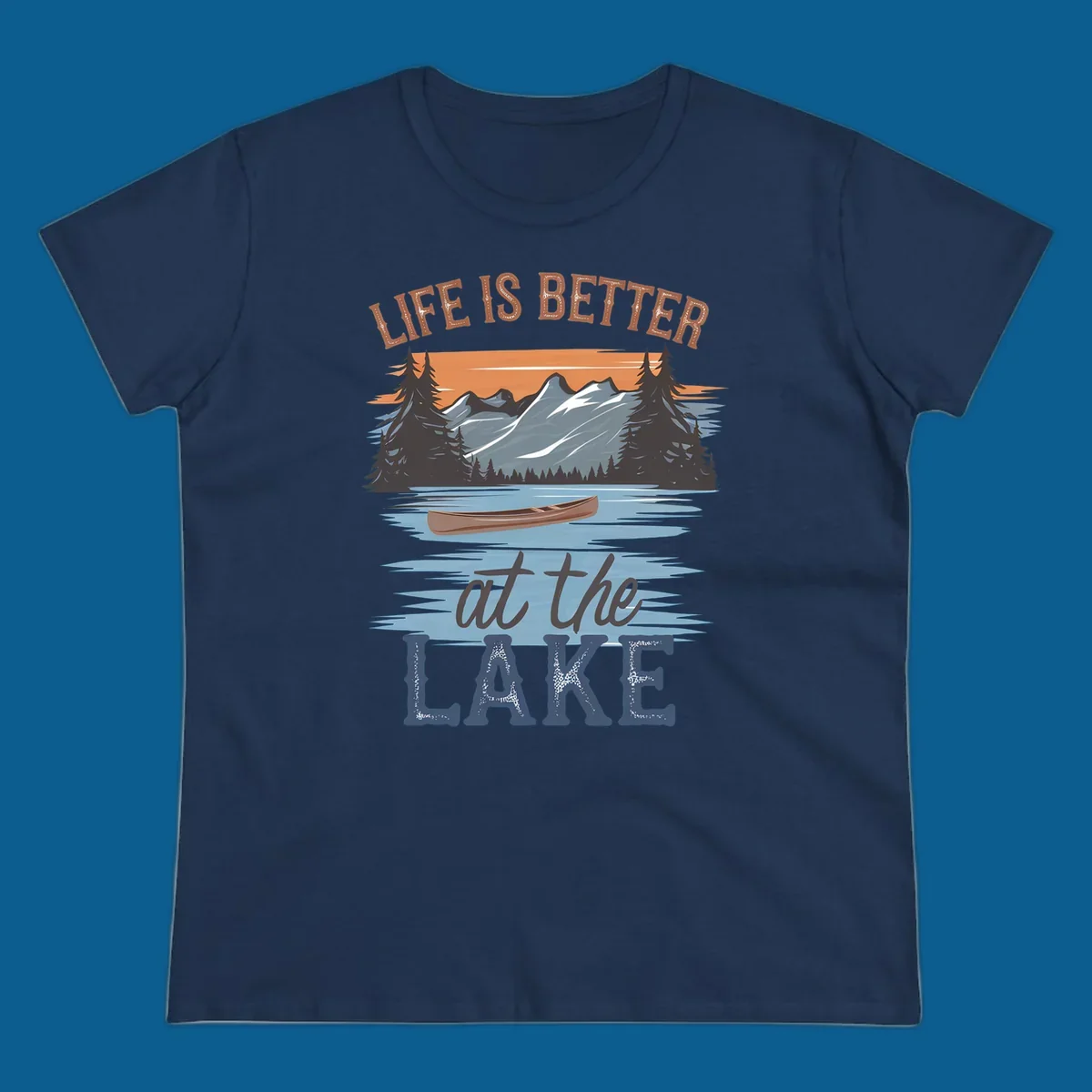 Life is better at the lake scenic design with mountains, canoe, and text.