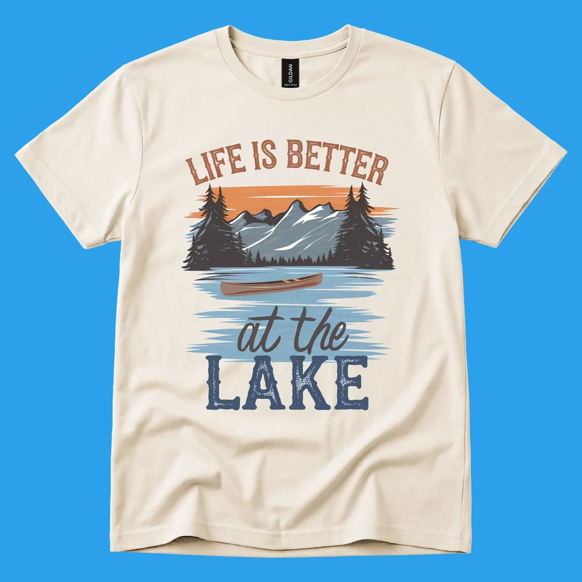 Life is better at the lake scenic design with mountains, canoe, and text.