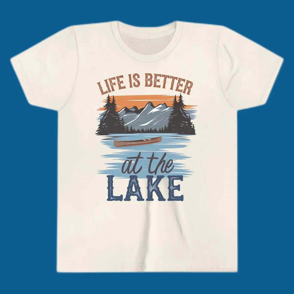 Life is better at the lake scenic design with mountains, canoe, and text.