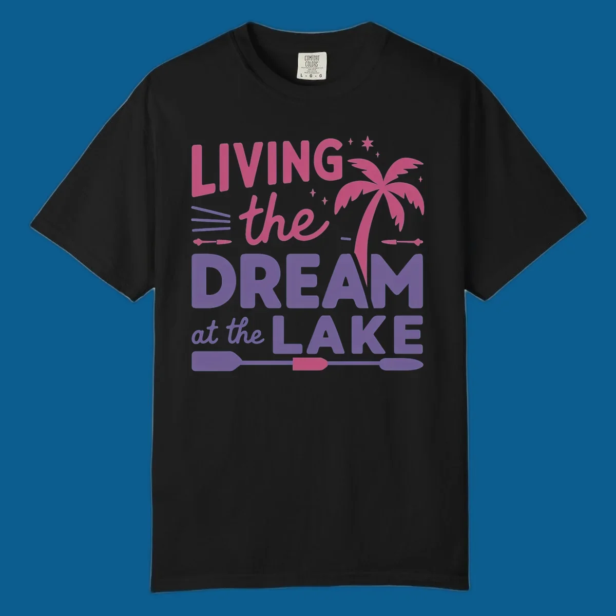 Living the dream at the lake text with palm tree and oars graphic