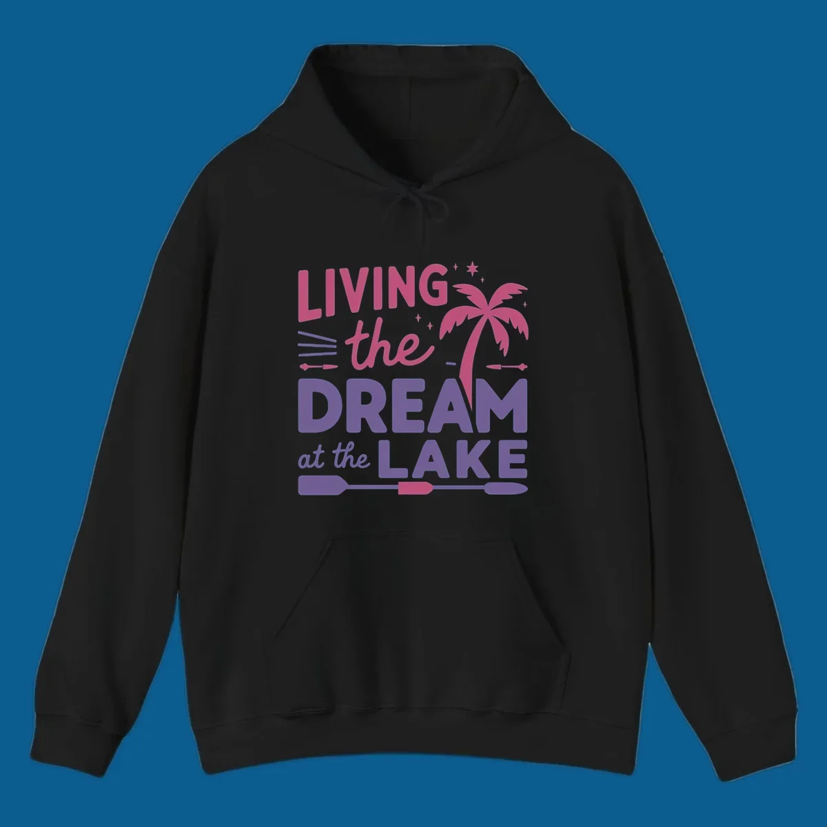 Living the dream at the lake text with palm tree and oars graphic