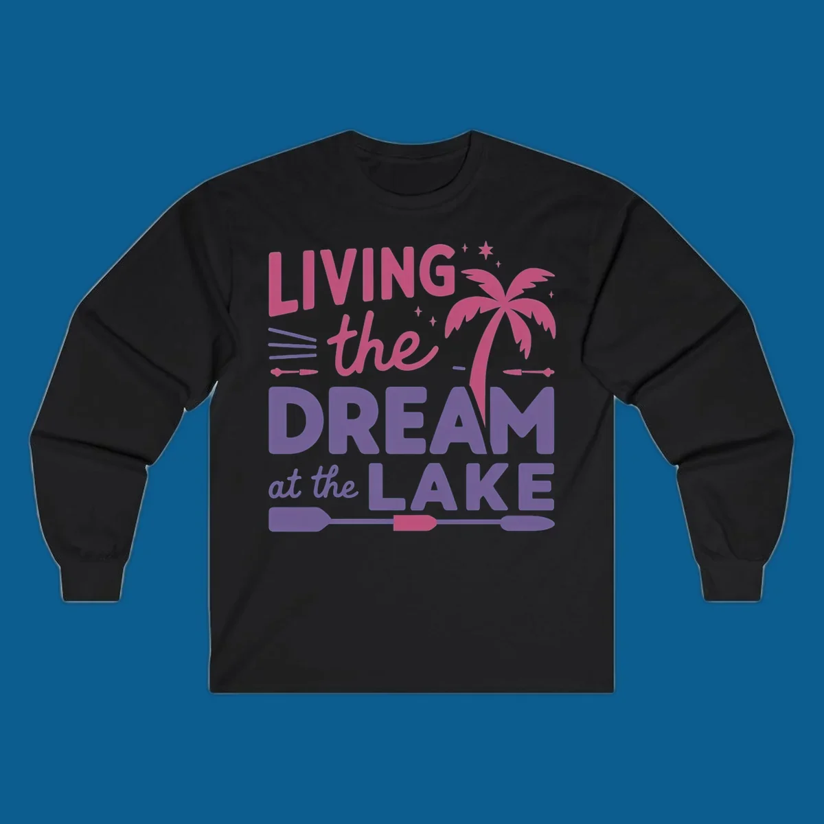 Living the dream at the lake text with palm tree and oars graphic