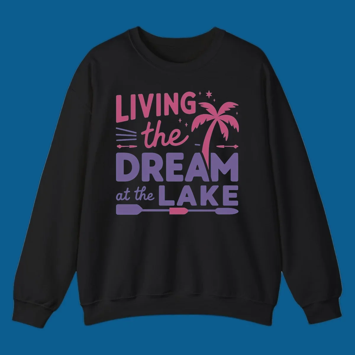 Living the dream at the lake text with palm tree and oars graphic
