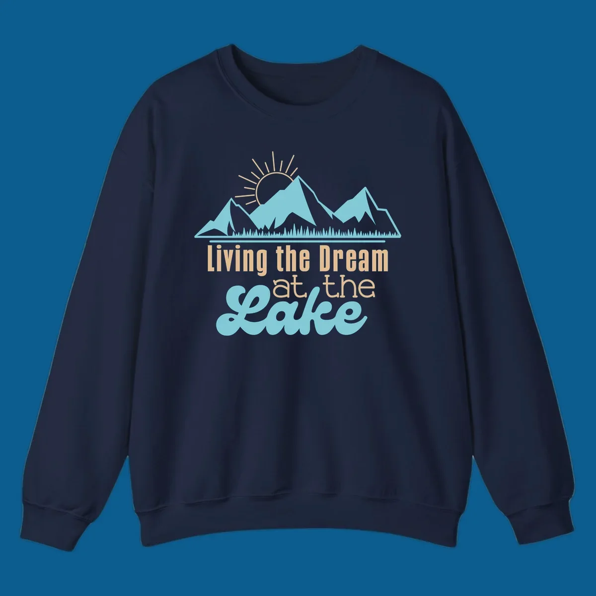 Scenic mountain range with sun and text 'Living the Dream at the Lake'.