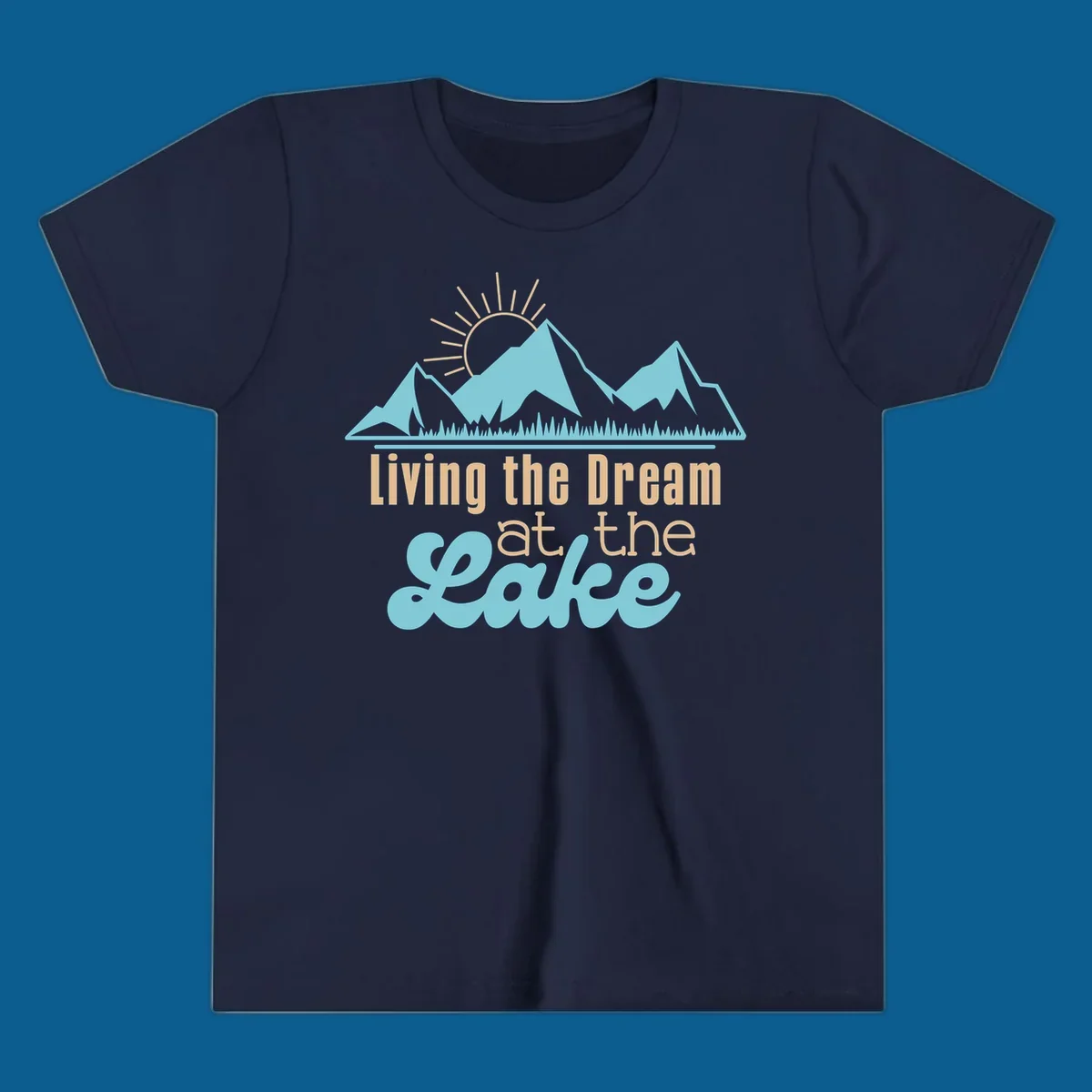 Scenic mountain range with sun and text 'Living the Dream at the Lake'.