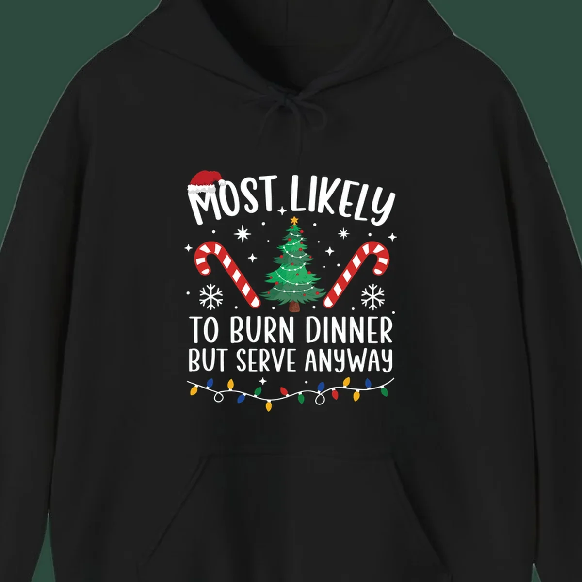 Most likely to burn dinner but serve anyway funny Christmas text with Santa hat, Christmas tree, and candy canes.