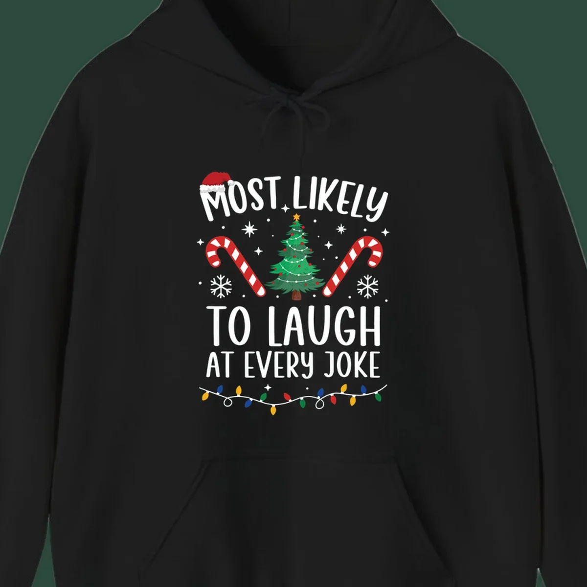 Most Likely To Laugh At Every Joke Christmas text with Santa hat, tree, candy canes, and lights.