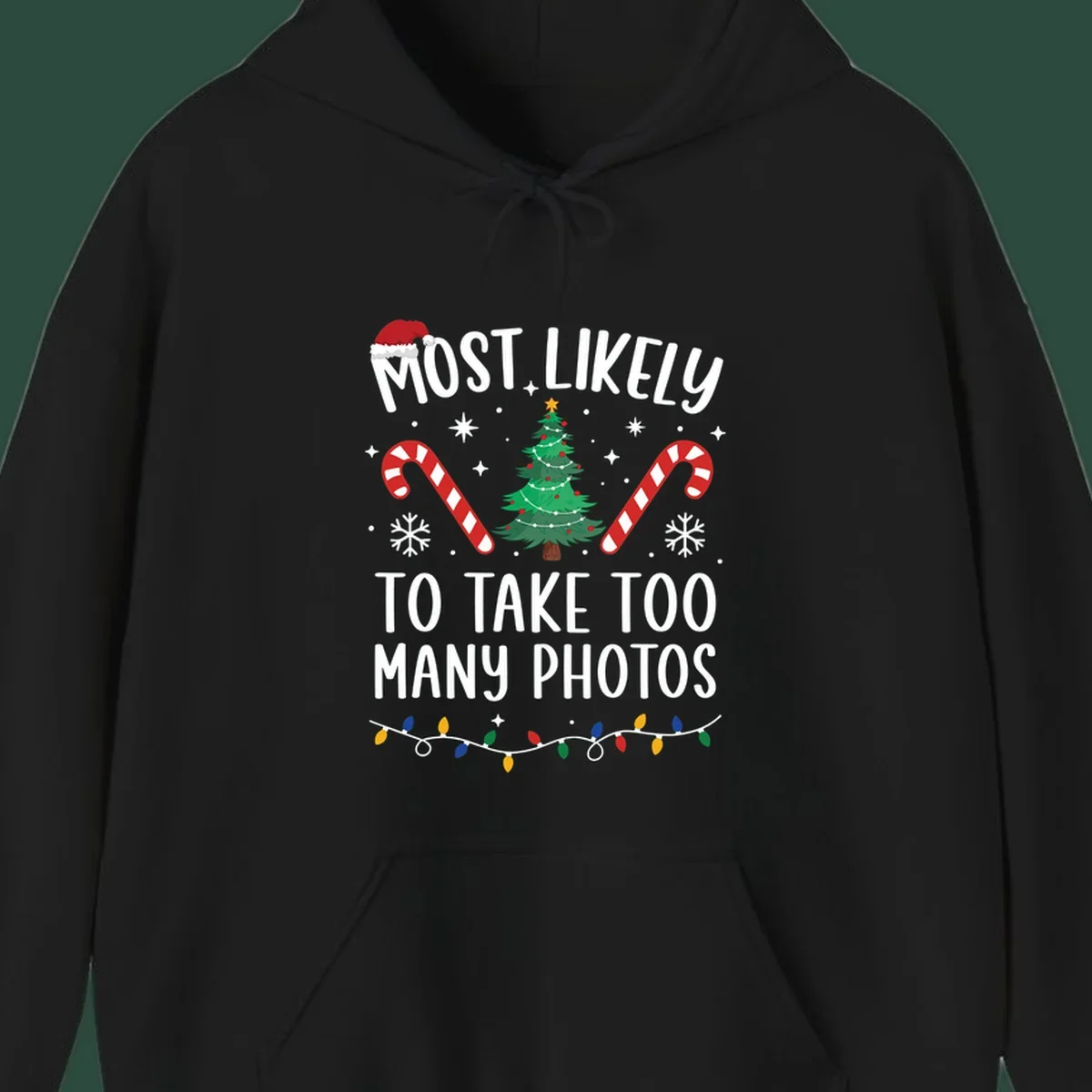 Most Likely To Take Too Many Photos Christmas design with text, candy canes, Christmas tree, and Santa hat.