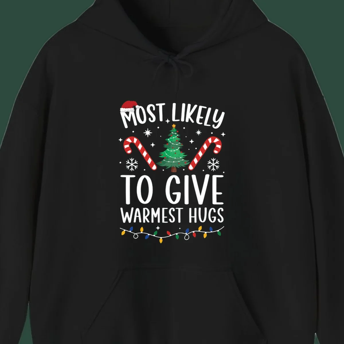 Christmas 'Most Likely To Give Warmest Hugs' design with tree, candy canes, and lights.