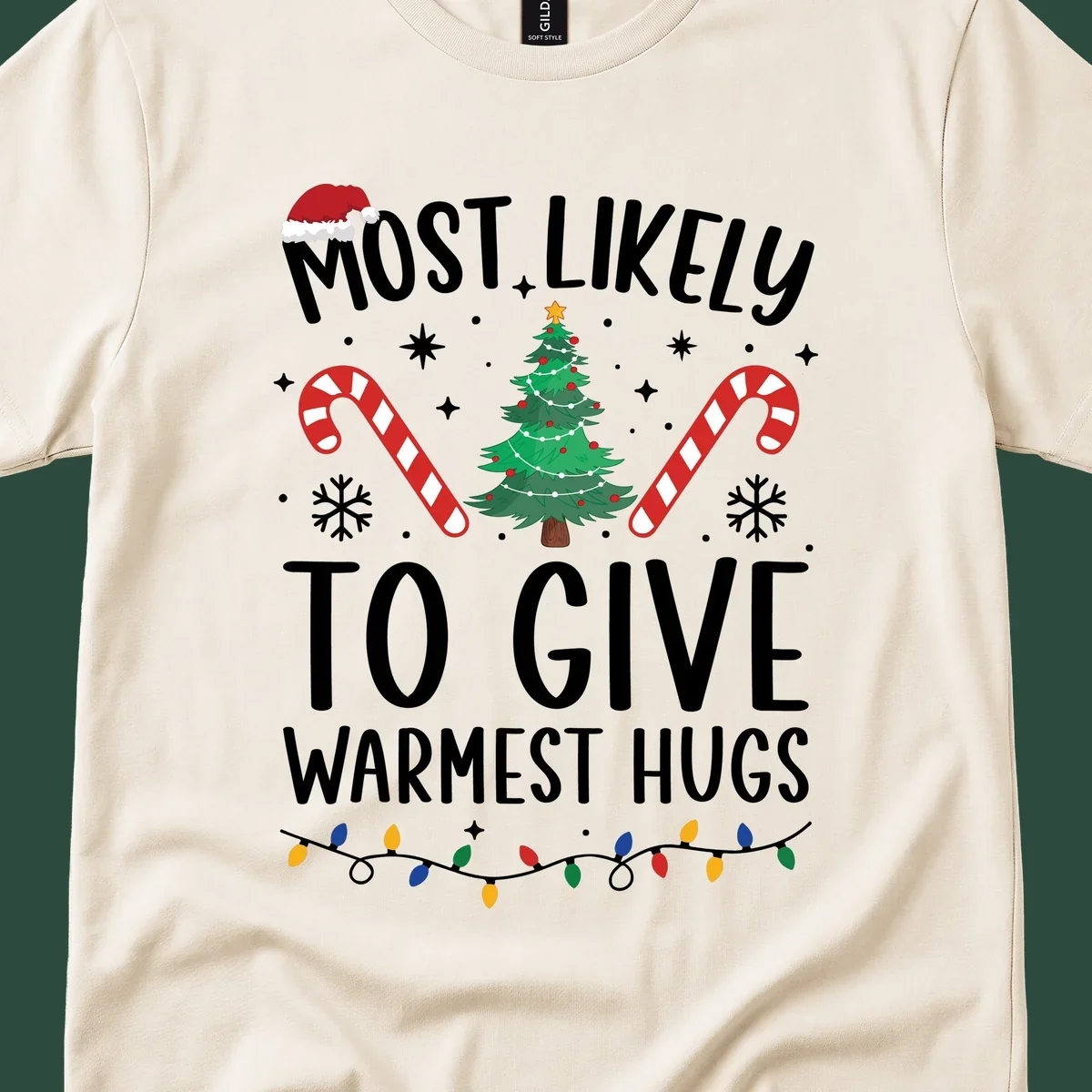 Christmas 'Most Likely To Give Warmest Hugs' design with tree, candy canes, and lights.